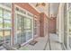 Inviting screened porch with brick accents and swing chairs, providing a relaxing outdoor space at 5647 S Blackmoor Dr., Murrells Inlet, SC 29576