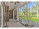 Charming screened porch with a ceiling fan and swing chairs, overlooking the beautiful backyard at 5647 S Blackmoor Dr., Murrells Inlet, SC 29576