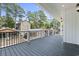 Covered porch featuring a grey deck and white columns at 6001 S Kings Hwy., Myrtle Beach, SC 29575