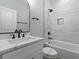 Elegant bathroom with a marble-style tiled wall, bathtub, and contemporary fixtures at 6001 S Kings Hwy., Myrtle Beach, SC 29575