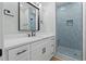 Stylish bathroom with white vanity, modern fixtures, and blue-tiled walk-in shower at 6001 S Kings Hwy., Myrtle Beach, SC 29575