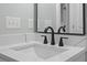 Modern bathroom featuring a stylish white sink and contemporary black faucet at 6001 S Kings Hwy., Myrtle Beach, SC 29575