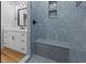 Bathroom featuring an accent-tiled shower with a bench, and a modern vanity at 6001 S Kings Hwy., Myrtle Beach, SC 29575