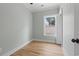 Light-filled bedroom with wood floors, fresh paint, and a bright window at 6001 S Kings Hwy., Myrtle Beach, SC 29575