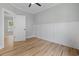 A light and airy bedroom featuring hardwood floors, white trim, and fresh, light green paint at 6001 S Kings Hwy., Myrtle Beach, SC 29575