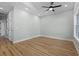 A modern bedroom with light green walls, hardwood floors, a ceiling fan, and recessed lighting at 6001 S Kings Hwy., Myrtle Beach, SC 29575