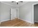 Light-filled bedroom with wood floors, fresh paint, and a door to another room at 6001 S Kings Hwy., Myrtle Beach, SC 29575