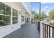 Spacious covered deck featuring black railing, white trim, and plenty of room for outdoor enjoyment at 6001 S Kings Hwy., Myrtle Beach, SC 29575