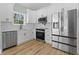 Bright kitchen features stainless steel appliances, white cabinets, and sleek countertops at 6001 S Kings Hwy., Myrtle Beach, SC 29575