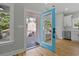 Light-filled kitchen featuring stainless steel appliances and a bright blue exterior door leading to the outside at 6001 S Kings Hwy., Myrtle Beach, SC 29575