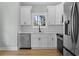 Bright kitchen features stainless steel appliances, white cabinets, and sleek countertops at 6001 S Kings Hwy., Myrtle Beach, SC 29575