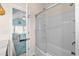 View from bathroom to bedroom showing tub/shower with glass enclosure, and coastal decor bedroom at 6001-1205 S Kings Hwy., Myrtle Beach, SC 29575