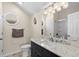 Well-lit bathroom featuring a granite vanity top, black cabinets, and tiled shower/tub enclosure at 6001-1205 S Kings Hwy., Myrtle Beach, SC 29575
