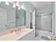 The bright bathroom features a marble vanity, tile floors, and a shower/tub with glass enclosure at 6001-1205 S Kings Hwy., Myrtle Beach, SC 29575