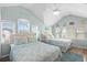 This bright bedroom features two beds, vaulted ceilings, and ample natural light from multiple windows at 6001-1205 S Kings Hwy., Myrtle Beach, SC 29575