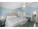 This coastal bedroom offers serene blue walls, vaulted ceiling, and sliding glass door to balcony at 6001-1205 S Kings Hwy., Myrtle Beach, SC 29575