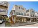 Beautiful elevated beach home with a balcony, parking, and a clear blue sky above at 6001-1205 S Kings Hwy., Myrtle Beach, SC 29575