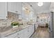 Modern kitchen with white cabinetry, stainless steel appliances, and an eat-in area at 6001-1205 S Kings Hwy., Myrtle Beach, SC 29575