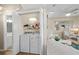 Laundry closet with stacked washer and dryer; adjoins spacious living room with coastal decor at 6001-1205 S Kings Hwy., Myrtle Beach, SC 29575