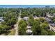 Aerial view showcases the neighborhood with lush trees, near ocean, and charming houses at 617 Sparrow Dr., Surfside Beach, SC 29575