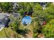 Aerial shot of the property showcasing its blue roof, surrounding trees and yard at 617 Sparrow Dr., Surfside Beach, SC 29575