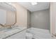 Bathroom with single sink, granite countertop, and tiled tub at 617 Sparrow Dr., Surfside Beach, SC 29575