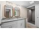 The bathroom has double sinks, granite countertop, and a tiled shower at 617 Sparrow Dr., Surfside Beach, SC 29575