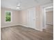 This bedroom features a ceiling fan, hardwood floors, and a window to let natural light in at 617 Sparrow Dr., Surfside Beach, SC 29575