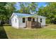 Charming home showcasing its inviting front porch and recently updated blue metal roof at 617 Sparrow Dr., Surfside Beach, SC 29575