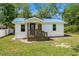 Charming home exterior with a blue roof, inviting entrance, and well-maintained lawn at 617 Sparrow Dr., Surfside Beach, SC 29575