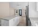 Open-concept kitchen with stainless appliances, granite countertops, and eat-in island at 617 Sparrow Dr., Surfside Beach, SC 29575