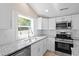 Well-lit kitchen with stainless appliances, granite countertops, and neutral decor at 617 Sparrow Dr., Surfside Beach, SC 29575