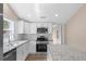 Modern kitchen boasts stainless steel appliances, white cabinets, and granite countertops at 617 Sparrow Dr., Surfside Beach, SC 29575