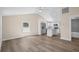 Open-concept home boasts cohesive spaces featuring neutral walls and sleek wood-look floors at 617 Sparrow Dr., Surfside Beach, SC 29575