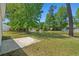 Expansive backyard view showcasing a pond with a fountain, lush trees and green lawn at 622 Oakhurst Dr., Myrtle Beach, SC 29579