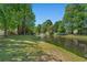 Picture of the pond with a fountain surrounded by green grass and some trees at 622 Oakhurst Dr., Myrtle Beach, SC 29579