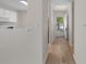 Bright hallway featuring wood-look laminate floors and an open view to the kitchen at 622 Oakhurst Dr., Myrtle Beach, SC 29579