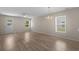 Bright living room featuring modern wood flooring and a classic chandelier at 622 Oakhurst Dr., Myrtle Beach, SC 29579
