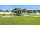 Picturesque picnic area by a tranquil pond, equipped with tables and grill at 622 Oakhurst Dr., Myrtle Beach, SC 29579