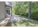 Back patio with a grill, overlooking a private backyard surrounded by mature trees at 6486 Somersby Dr., Murrells Inlet, SC 29576