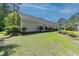 A view of the home's backyard and exterior, featuring a well manicured lawn at 6486 Somersby Dr., Murrells Inlet, SC 29576