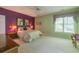 Bright bedroom with complementary purple accent wall, green walls, and large window at 6486 Somersby Dr., Murrells Inlet, SC 29576