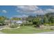 Beautiful community clubhouse surrounded by lush landscaping, with American flags waving in the breeze at 6486 Somersby Dr., Murrells Inlet, SC 29576