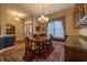 Inviting dining room featuring hardwood floors, elegant chandelier, and a large window for natural light at 6486 Somersby Dr., Murrells Inlet, SC 29576