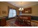 Inviting dining room featuring hardwood floors, elegant chandelier, and a large window for natural light at 6486 Somersby Dr., Murrells Inlet, SC 29576