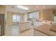 Bright eat-in kitchen with white cabinets, center island, neutral countertops, and tile flooring at 6486 Somersby Dr., Murrells Inlet, SC 29576