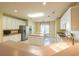 Bright eat-in kitchen features white cabinets, center island, neutral countertops, and stainless steel refrigerator at 6486 Somersby Dr., Murrells Inlet, SC 29576
