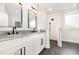 Stylish bathroom boasting double vanities, granite counters, and a walk-in shower at 7103 Louisville Rd., Aynor, SC 29511