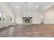 Bright, open living room featuring hardwood floors, fireplace, and neutral wall paint at 7103 Louisville Rd., Aynor, SC 29511