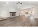 Bright, open living room featuring hardwood floors, fireplace, neutral paint, and an open layout to the kitchen at 7103 Louisville Rd., Aynor, SC 29511